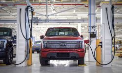 A red electric car being charged