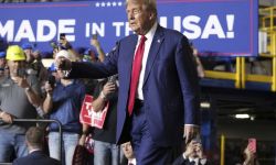 Republican presidential nominee former President Donald Trump walks on to the stage in Walker, Mich