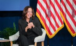 Vice President Kamala Harris speaking into a microphone