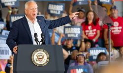 Tim Walz on stage at a rally in Michigan