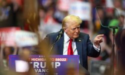 Donald Trump, on stage at a rally, pointing to the audience 