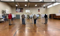 People in a school gym, voting