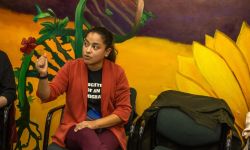 Detroit City Council Member Gabriela Santiago-Romero sitting in front of a mural