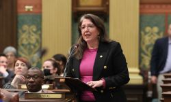 Woman stands in Michigan House Chambers