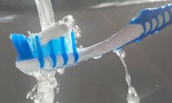  blue toothbrush and fluoride toothpaste