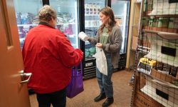 Two people looking at items at a food pantry 