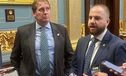 Republican state Sen. Ed McBroom, left, and Democratic Sen. Jeremy Moss stand next to each. They are talking to reporters.