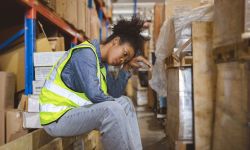 Tired stress woman worker labor working in warehouse