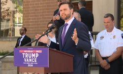 Vice President JD Vance speaking into a microphone in Michigan.