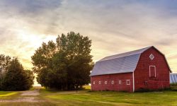 A red barn at sunset. 