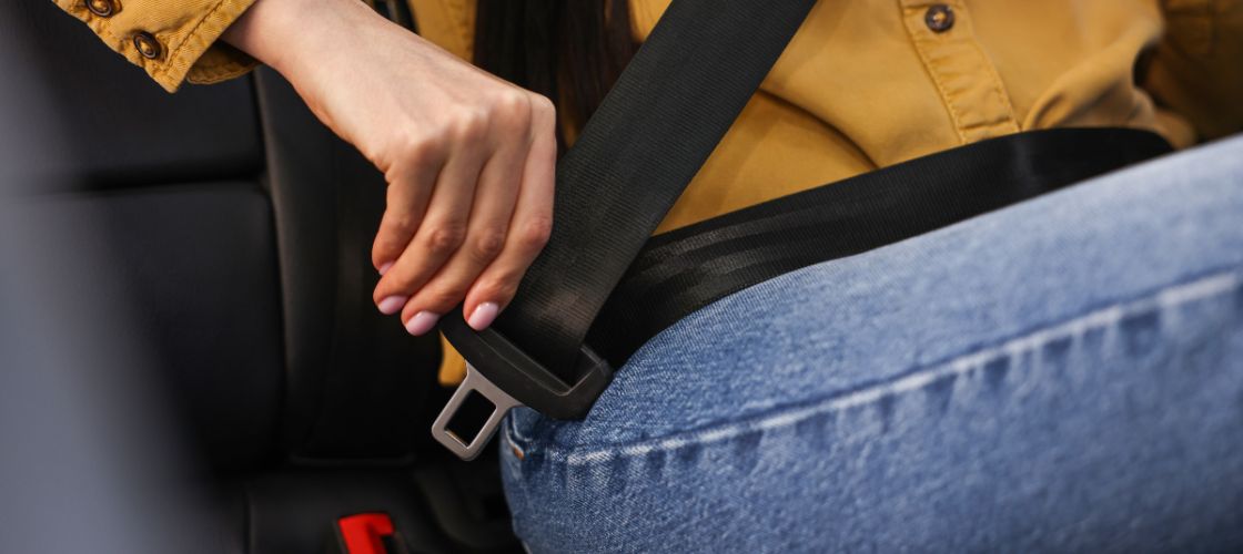 Woman buckles seat belt