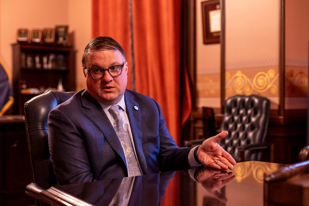 Michigan House Speaker Matt Hall sits at a table.