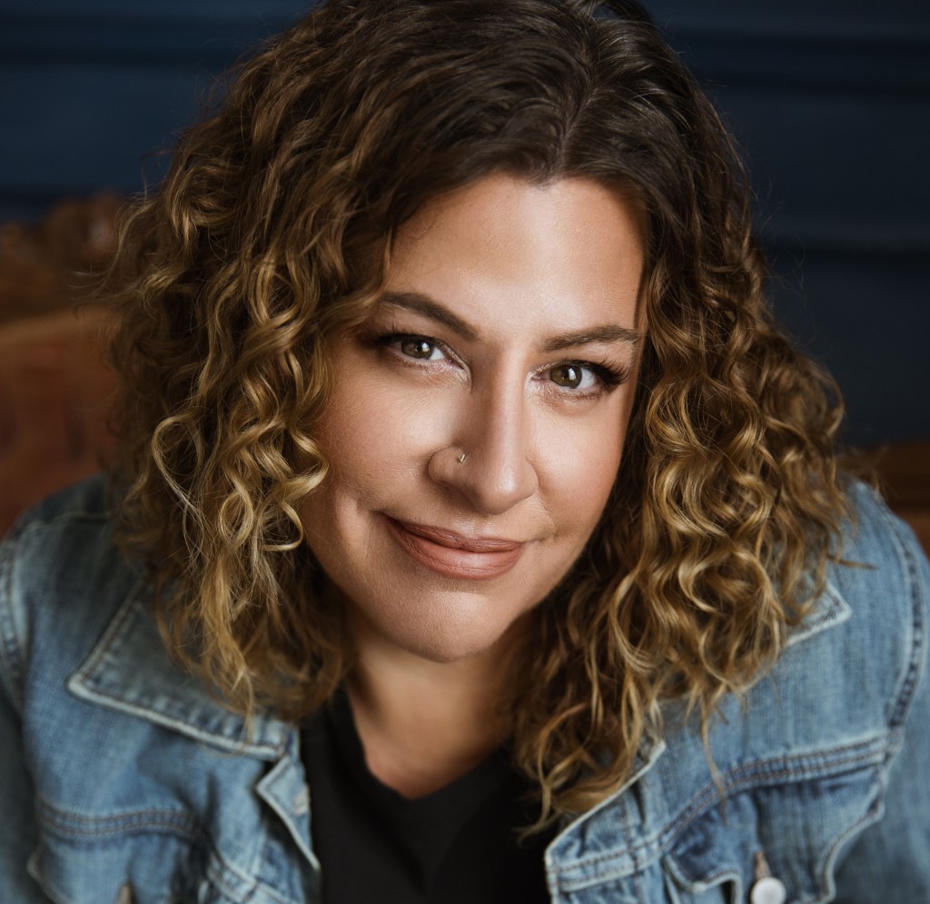 close headshot of a woman looking up at the camer