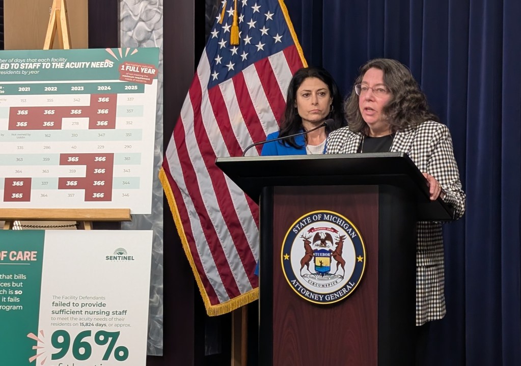 A woman at a podium during a press conference