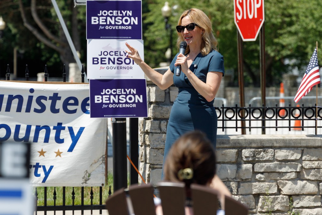 Jocelyn Benson speaks into a microphone.