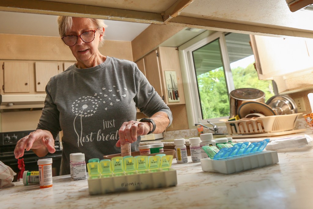 A woman prepares food at a kitchen counter