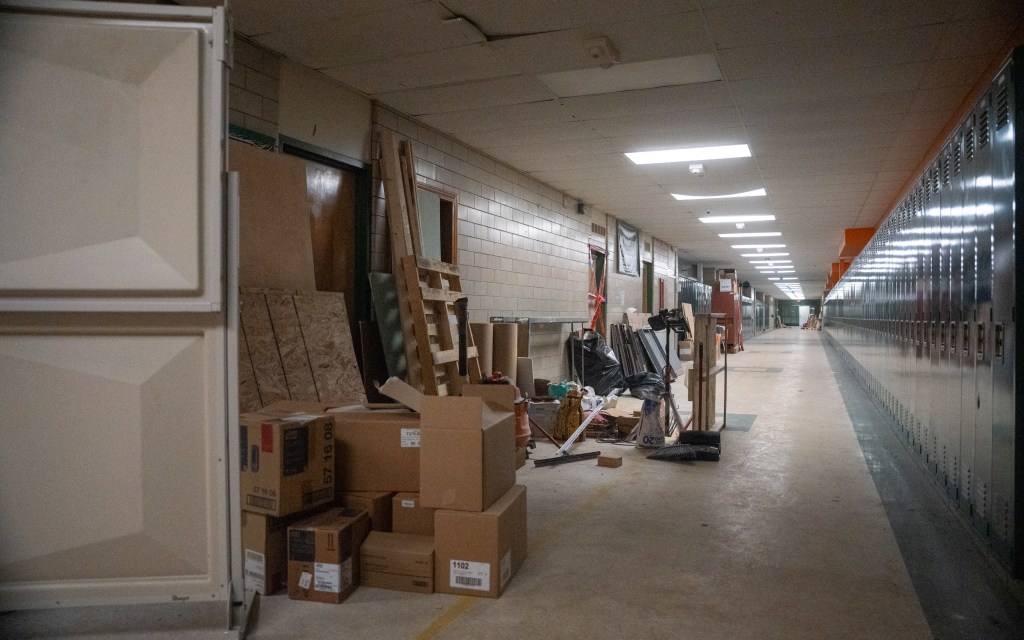 construction equipment stacked on the walls of a school hallway.