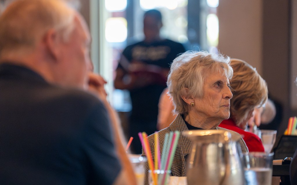 woman listens at an event