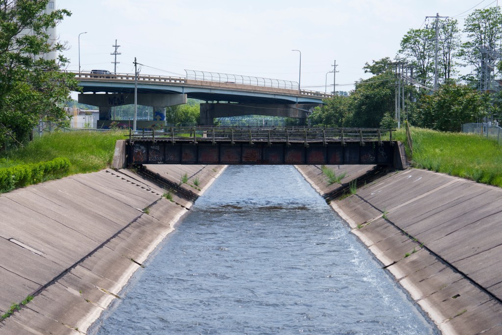 A river flows through a concrete channel